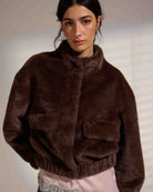faux fur jacket in brown with fold over pockets and a highs collar