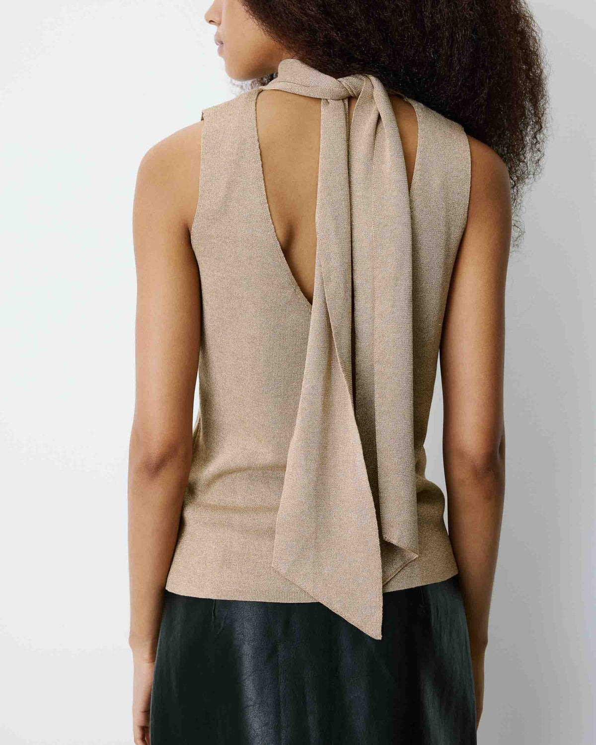 sleeveless gold knit top with tie at the back