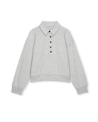 a light gray knit long-sleeve sweater with black buttons halfway down