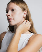 gold stud earrings in a bean shape