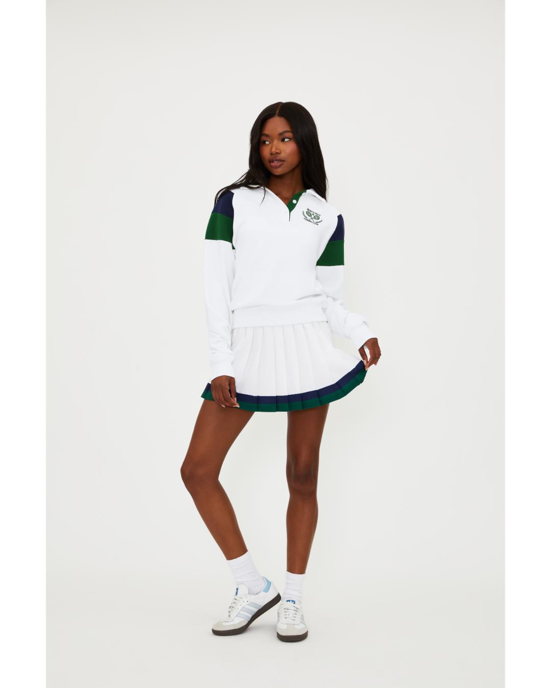 white polo long sleeve with navy and green stripe on the shoulders 