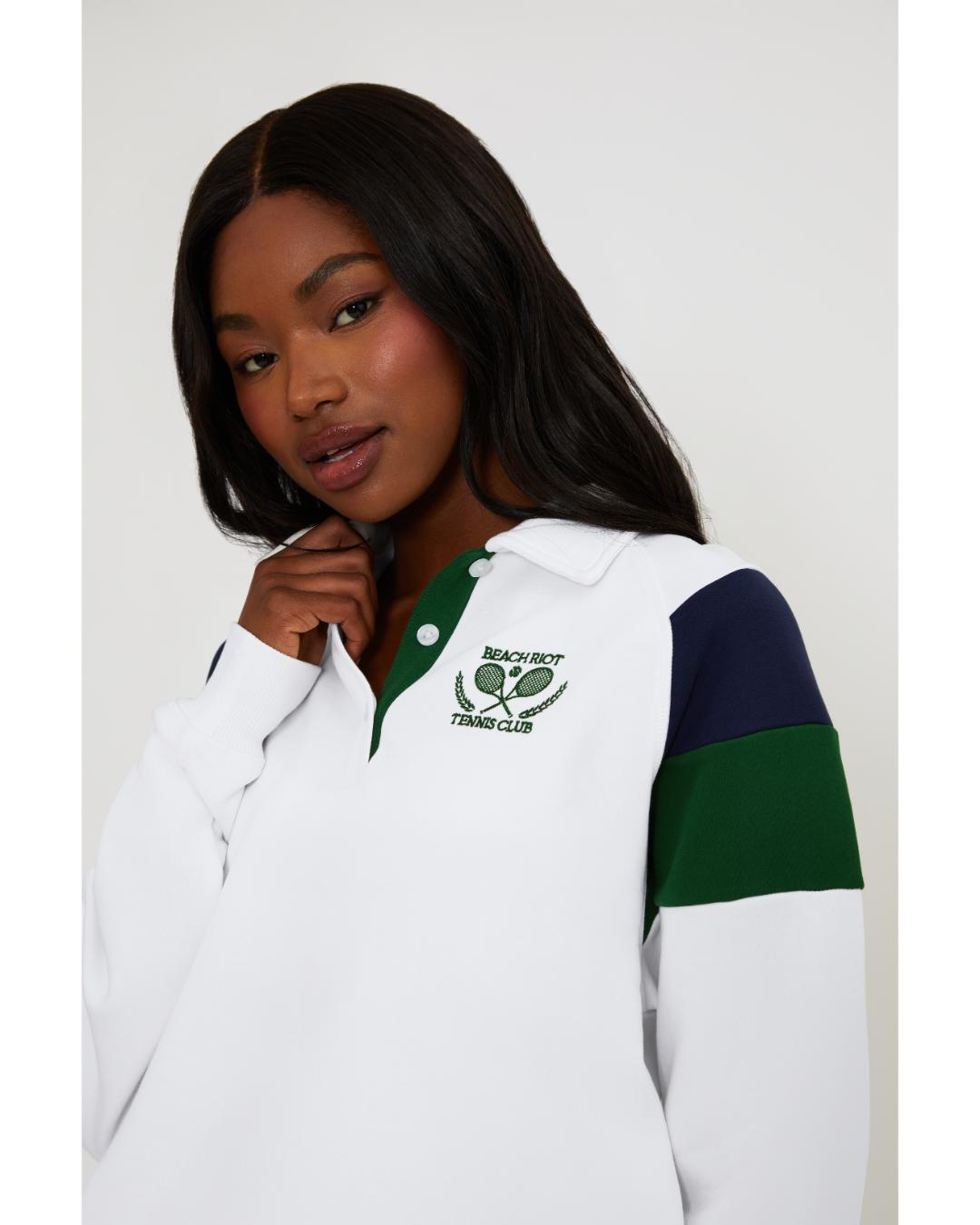 white polo long sleeve with navy and green stripe on the shoulders 