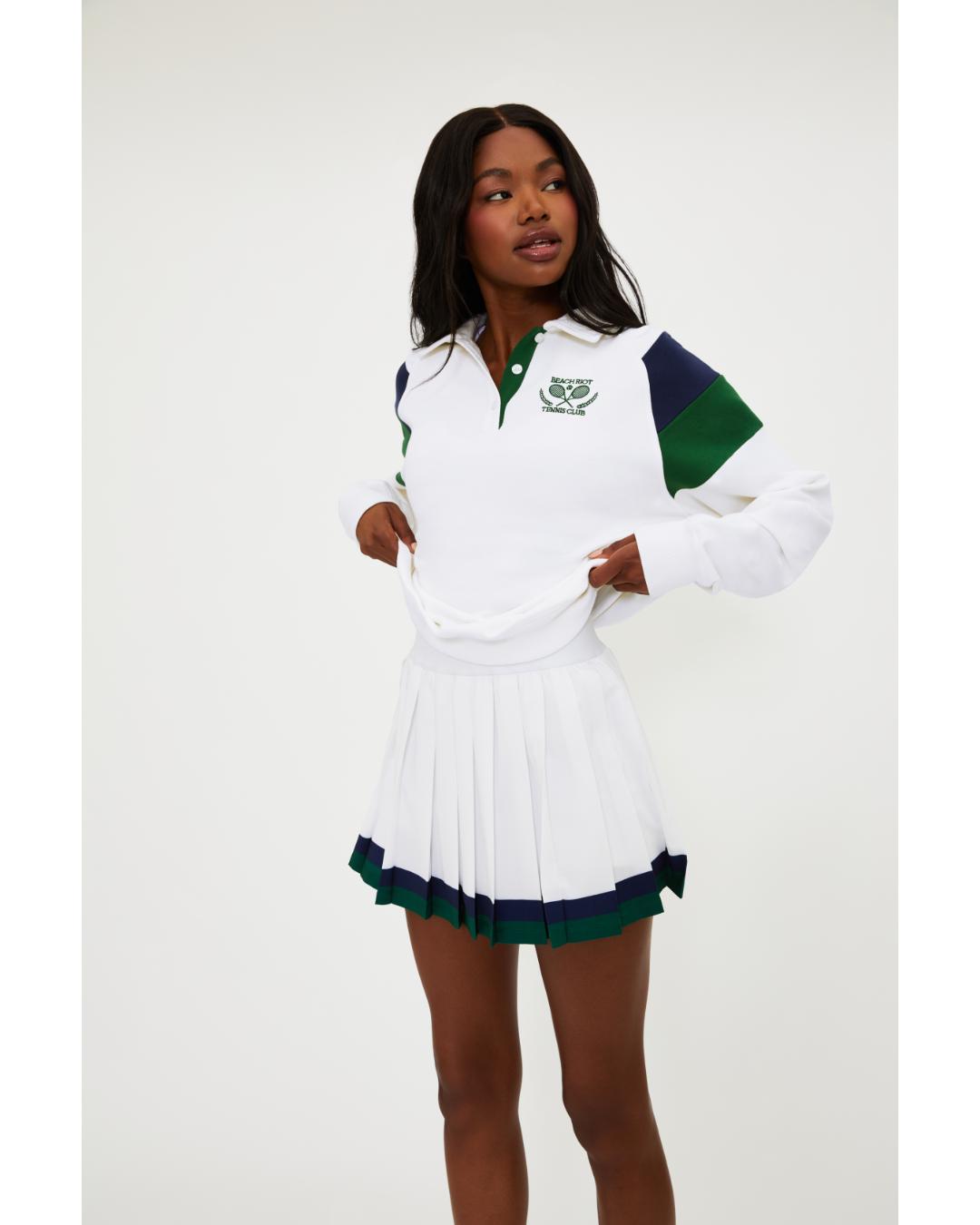 white polo long sleeve with navy and green stripe on the shoulders 