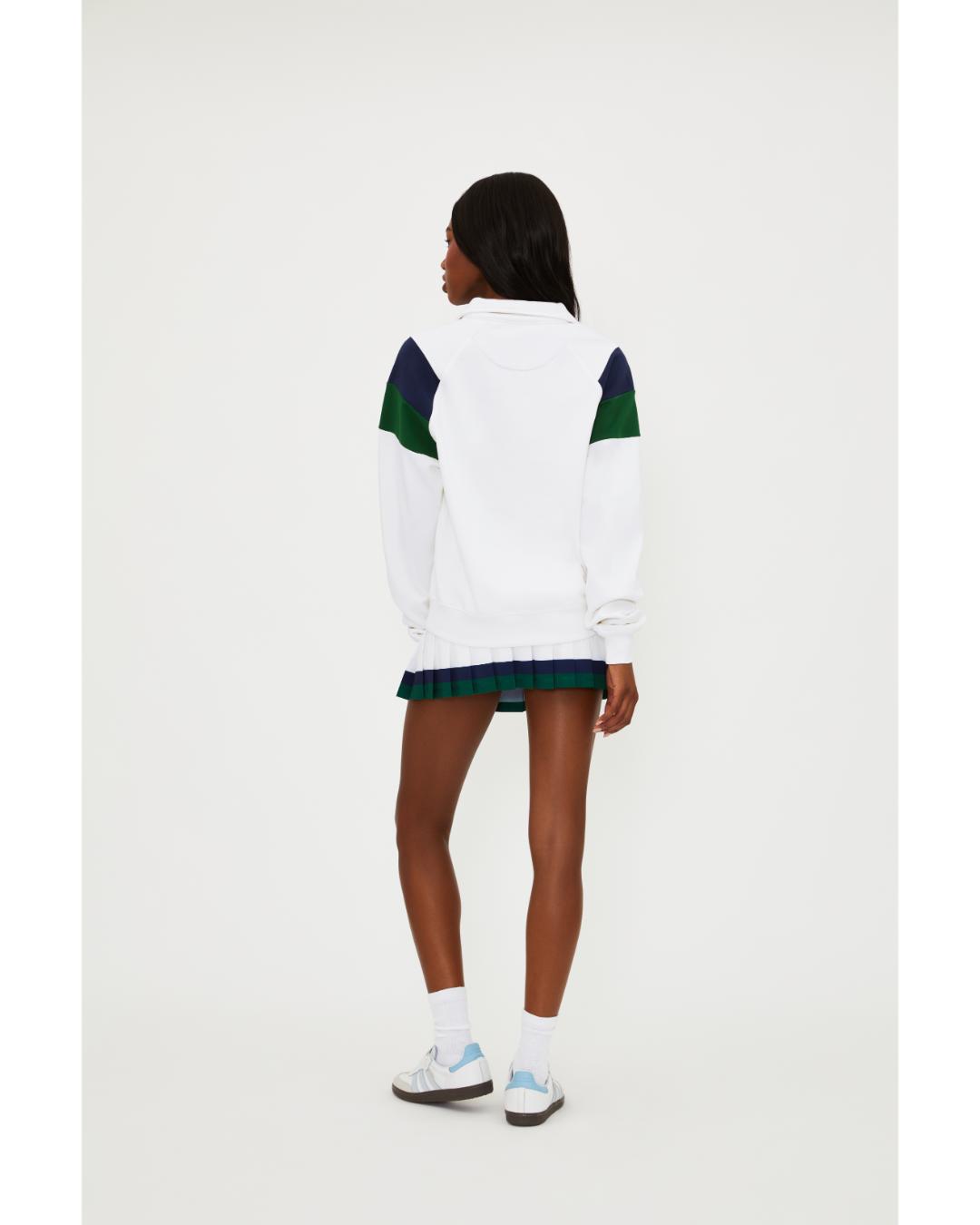 white polo long sleeve with navy and green stripe on the shoulders 