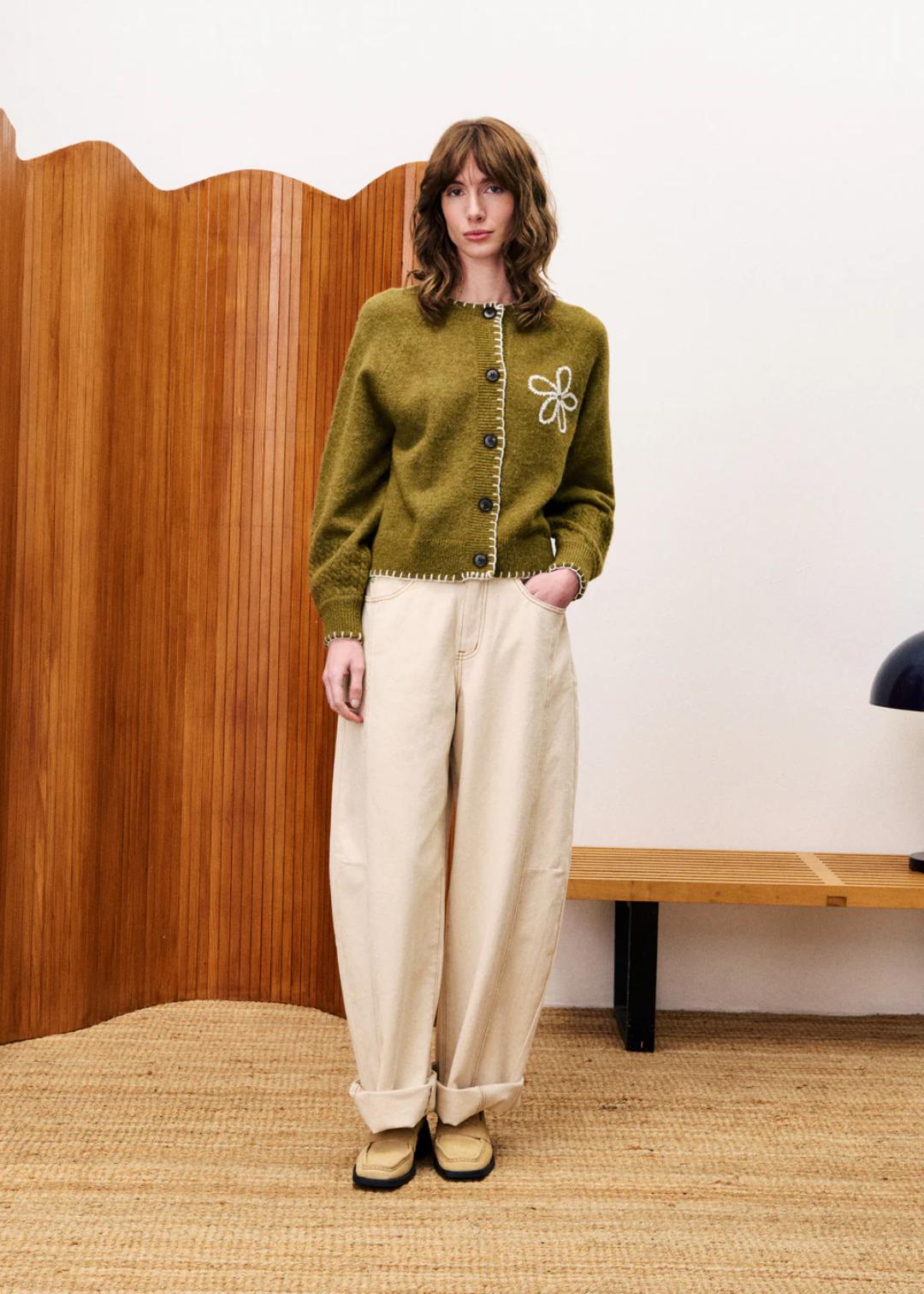 button up cardigan in khaki green with a knit flower on one side of the chest