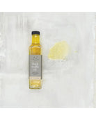Bottle of black truffle oil on a textured white background