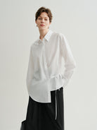 white blouse with a tie at the bottom