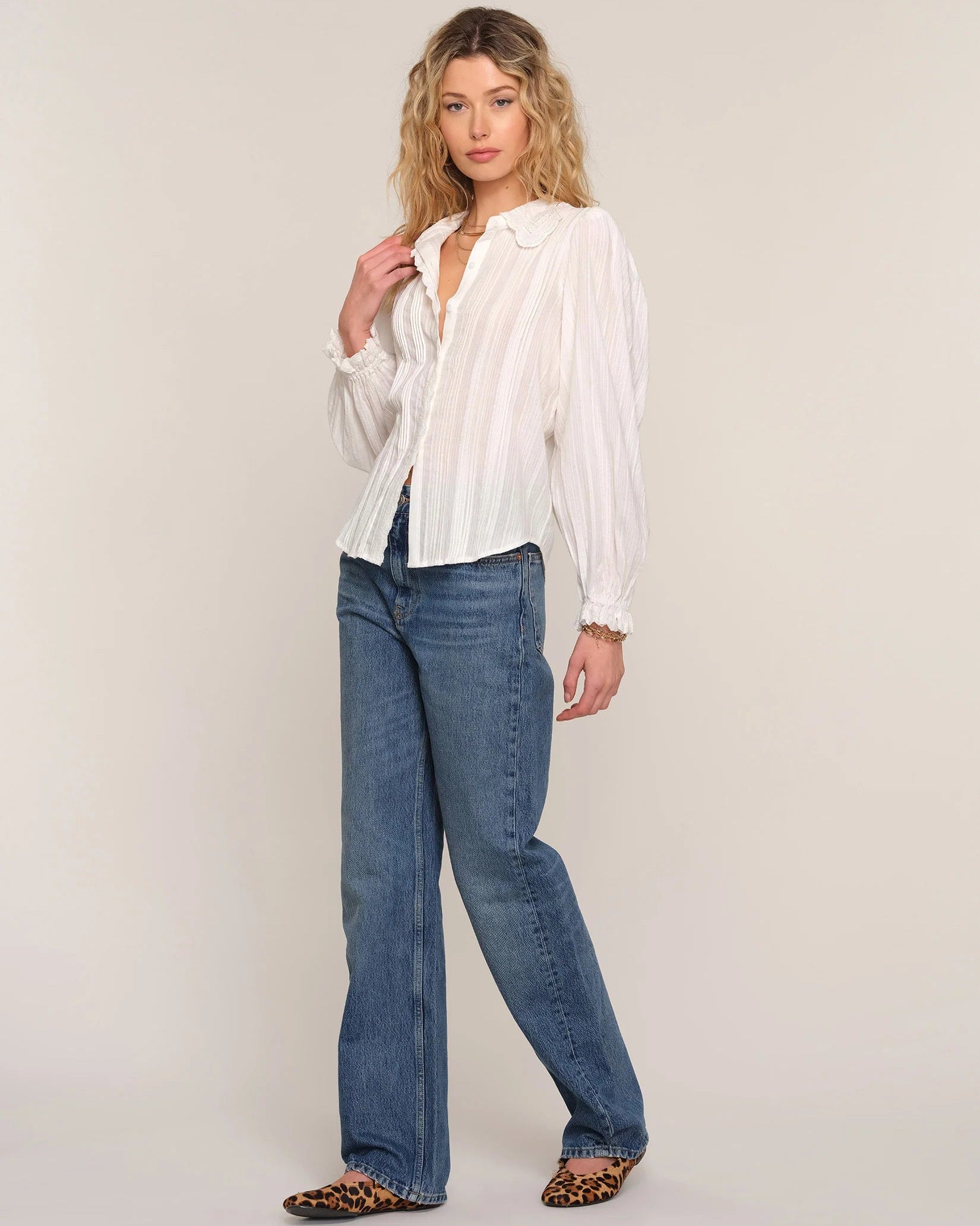 white blouse with lace trim on sleeves and collar