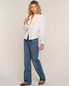 white blouse with lace trim on sleeves and collar