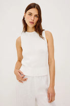 white sleeveless knit top