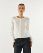 Woman wearing a white button down cardigan sweater
