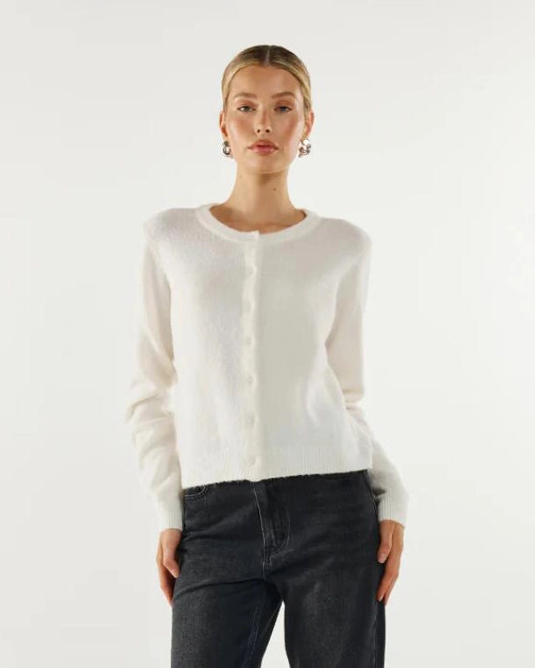 Woman wearing a white button down cardigan sweater