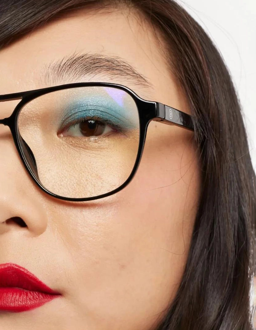 a woman wears a pair of black aviator eyeglasses for blue light by Barner
