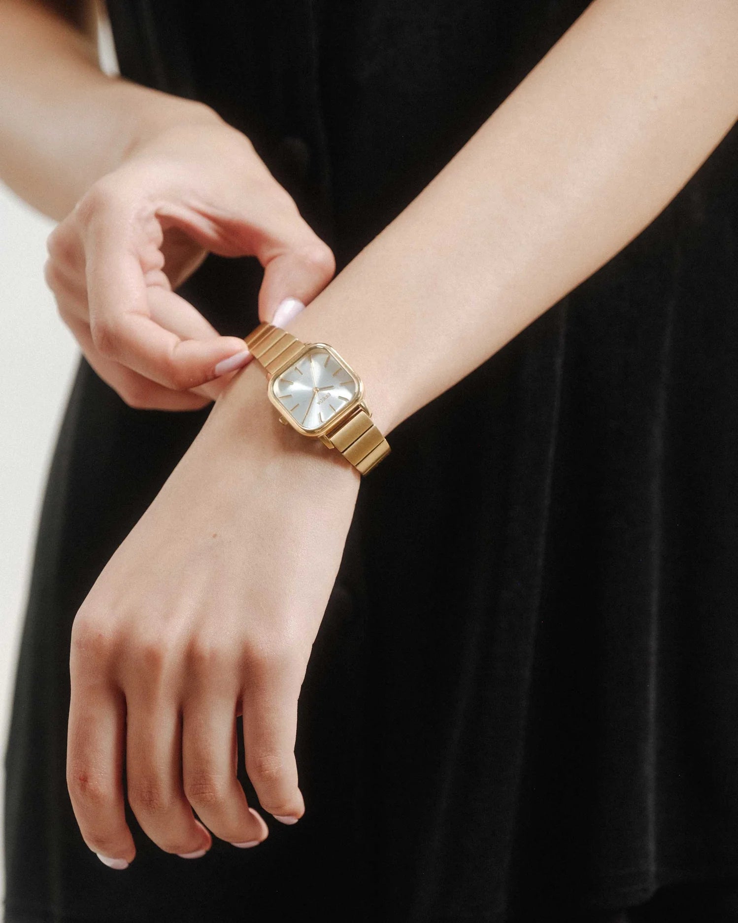 gold square face watch with pearl face