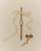gold textured watch with pearl face