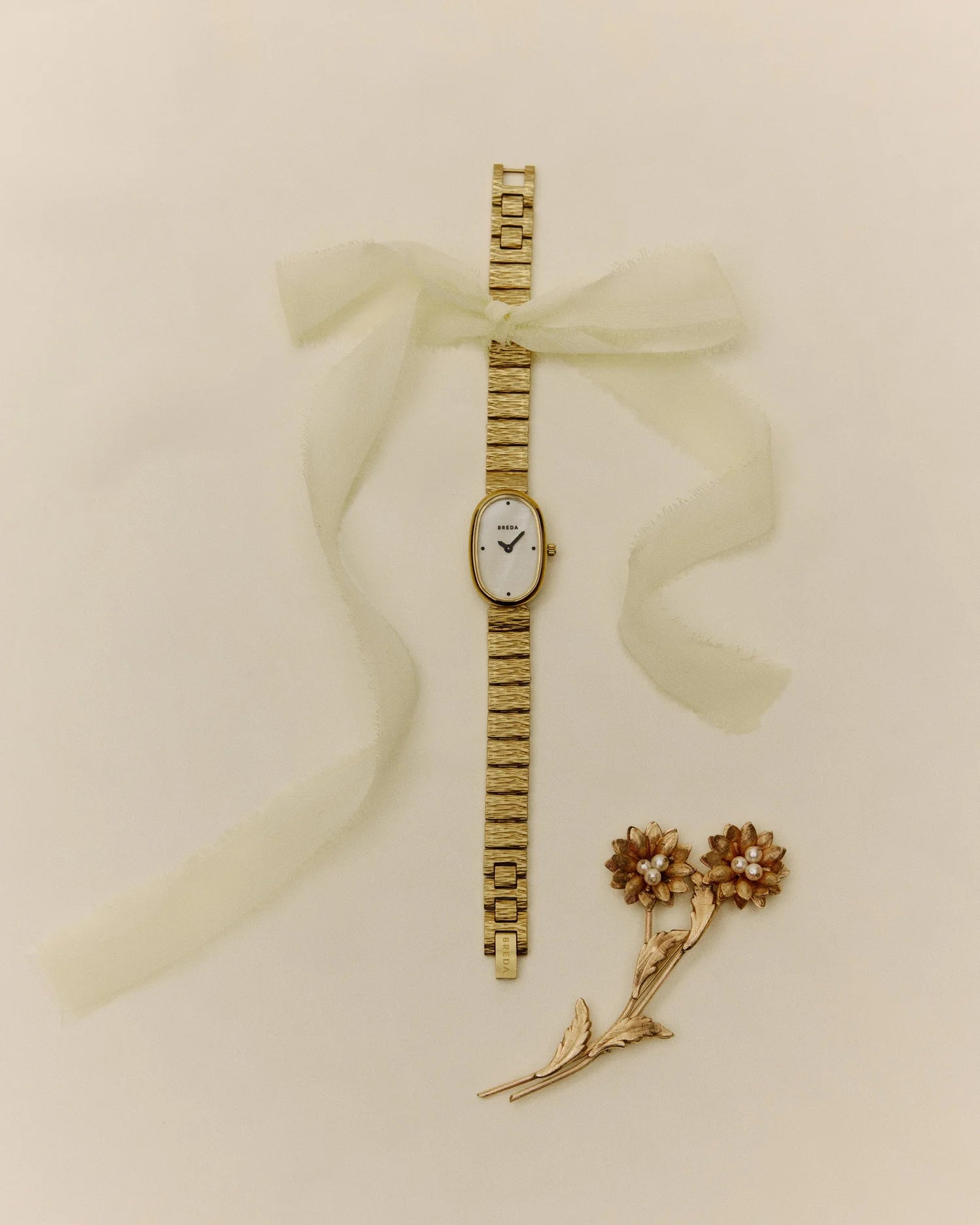 gold textured watch with pearl face