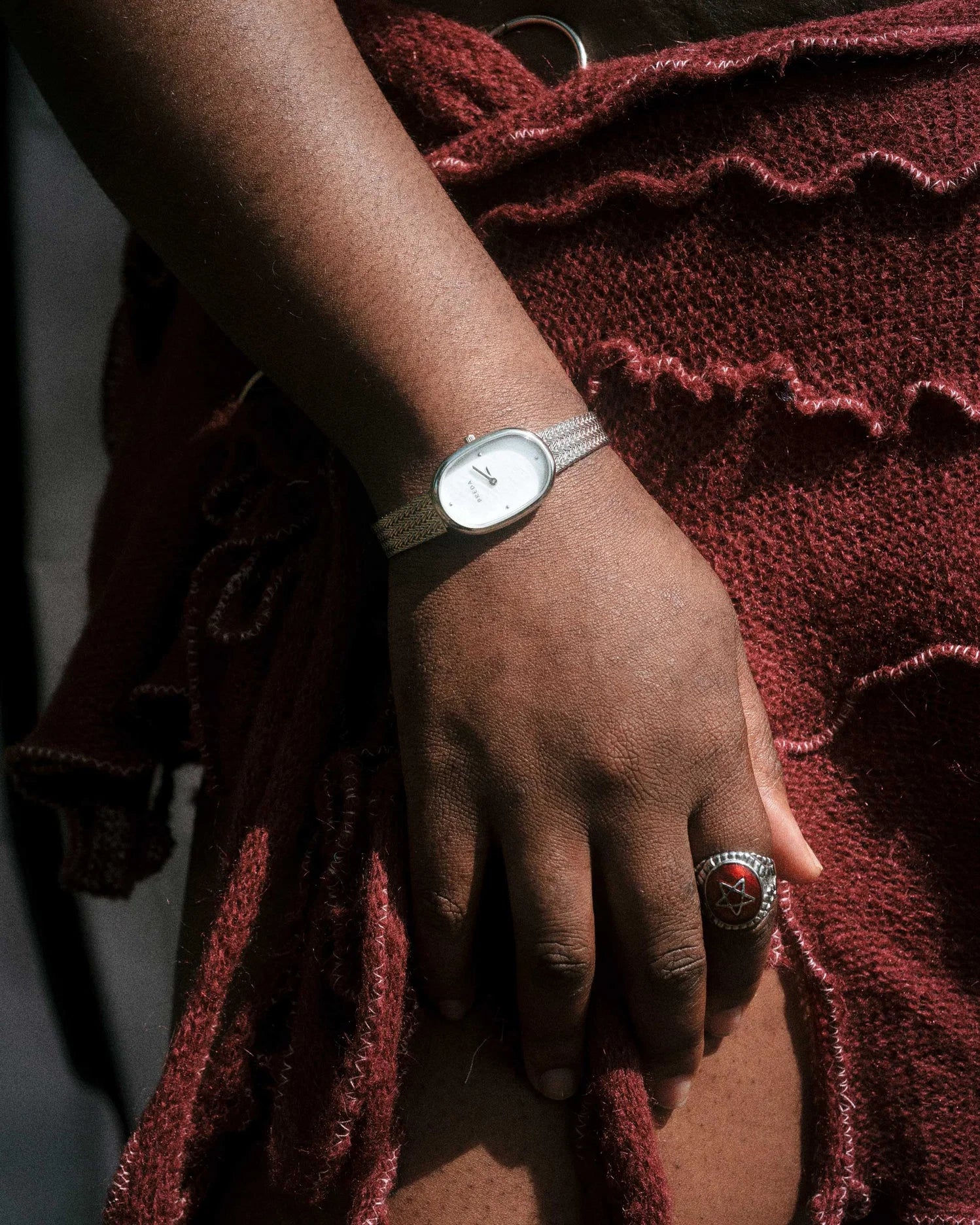 silver oval watch with pearl face