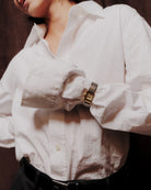 silver band and gold face watch