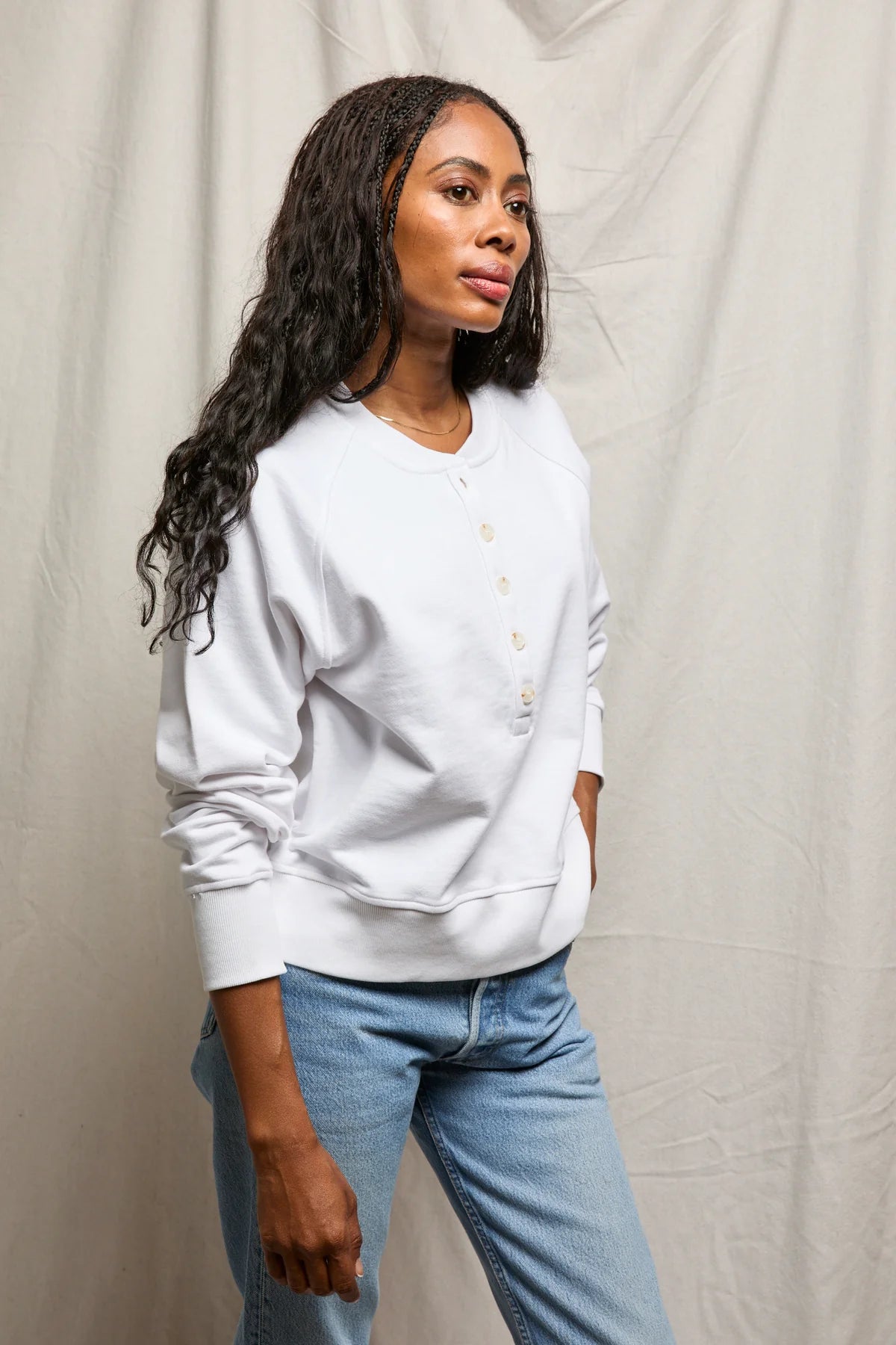 white sweater with buttons halfway down 