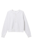 white sweater with buttons halfway down 