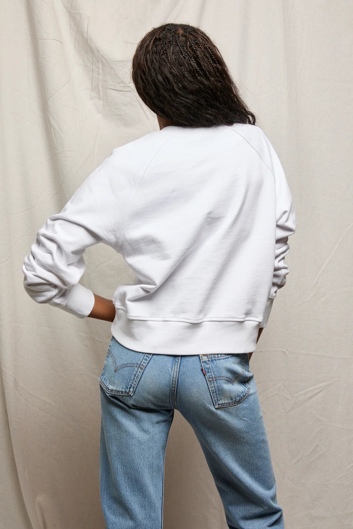 white sweater with buttons halfway down 