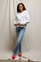 white sweater with buttons halfway down 