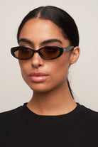 black oval sunglasses with brown lenses
