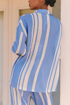 Woman wearing a blue and white striped shirt