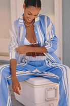 Woman wearing a blue and white striped shirt