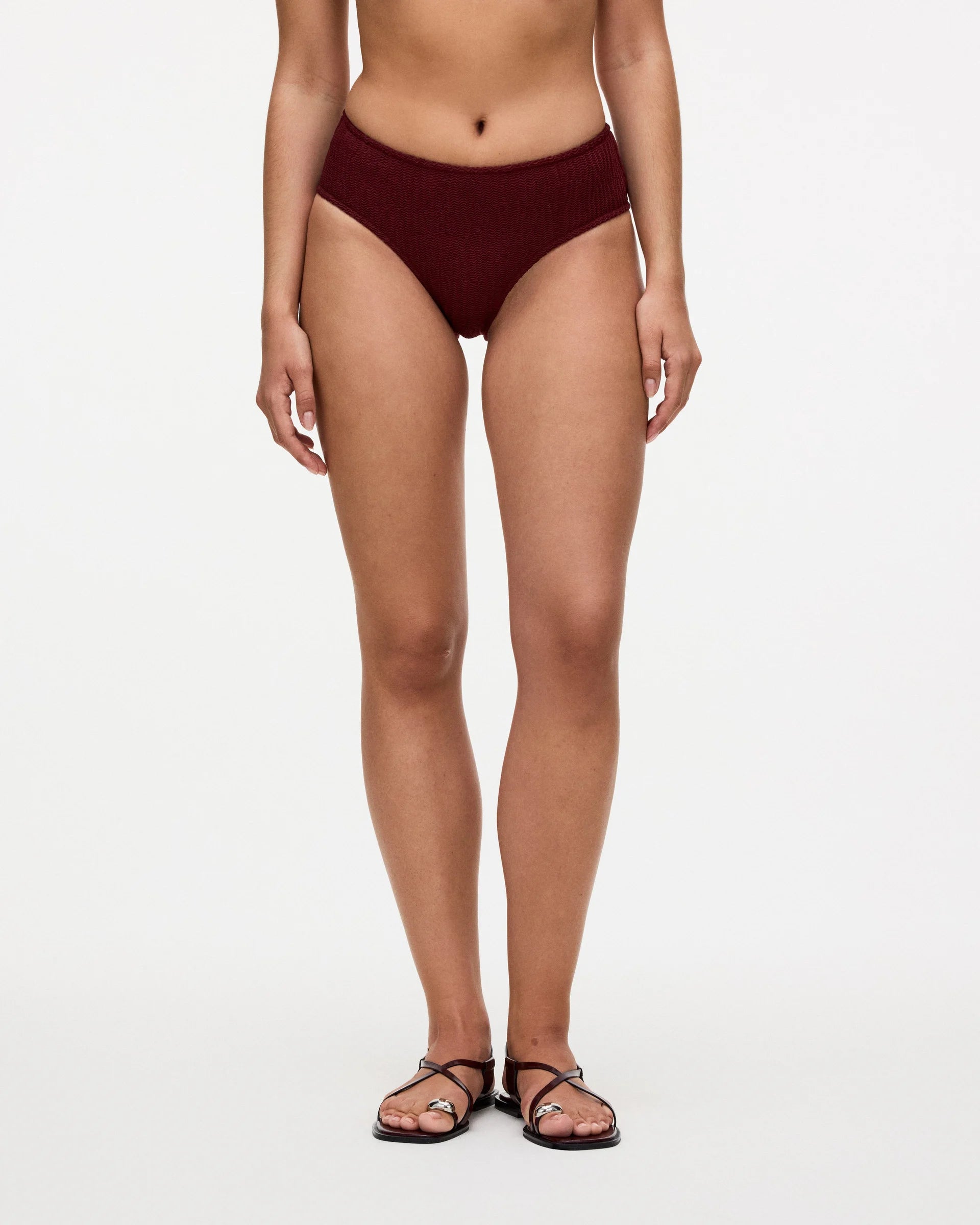 a red bikini bottom that has a knotted ribbed material