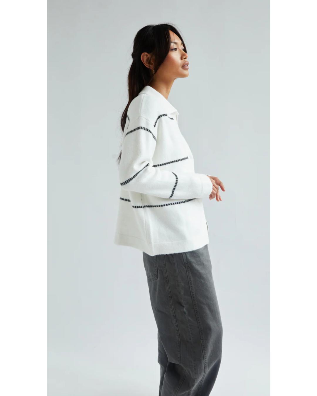 white cardigan with a collar and with black stripes