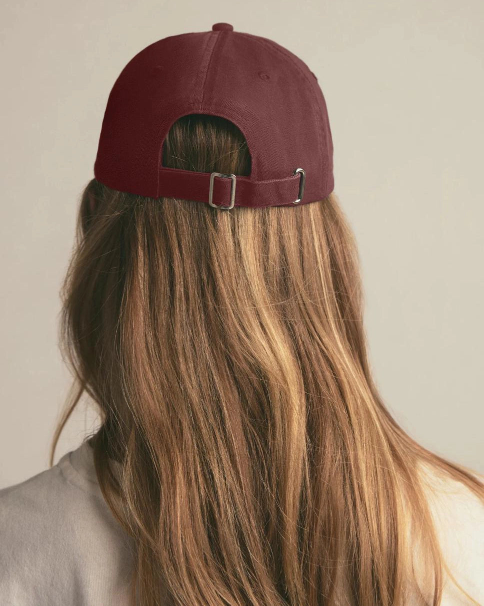 woman wearing a maroon baseball cap with 'Favorite Daughter' text on it