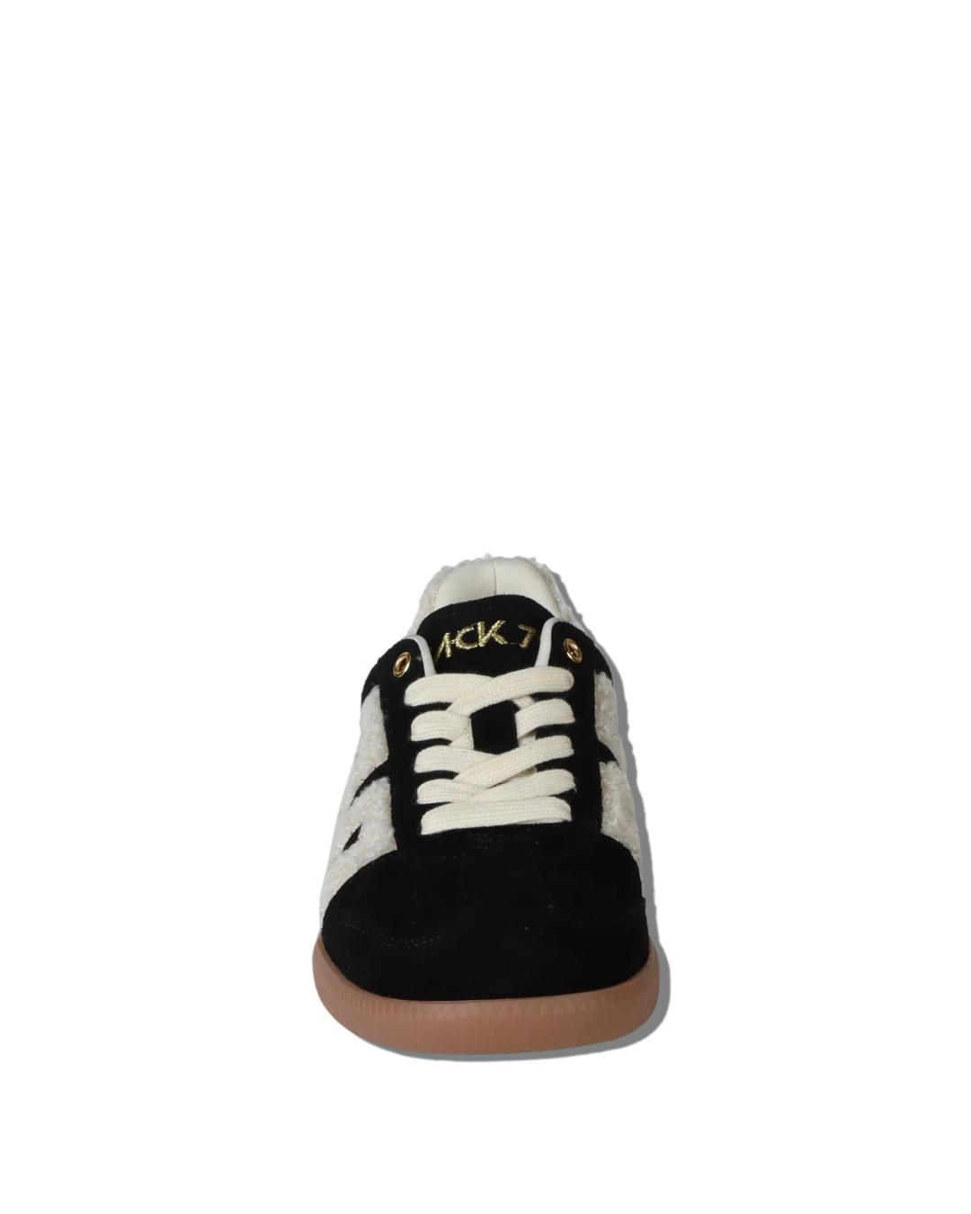 black suede sneaker with 70 written in white