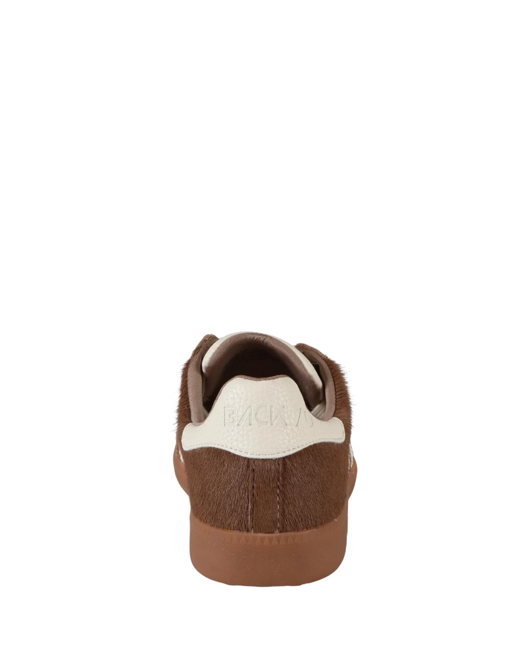 taupe sneaker with 70 on it in white