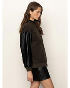 varsity jacket with black faux leather sleeves and a deep green front and back