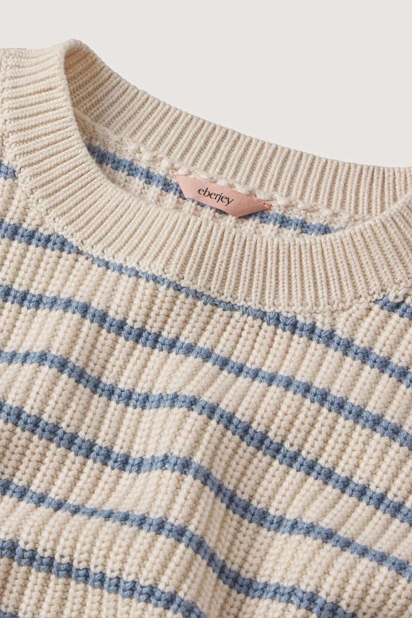 cream sweater with a light blue stripe