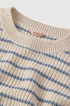 cream sweater with a light blue stripe