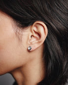 silver stud earrings with gem in the middle