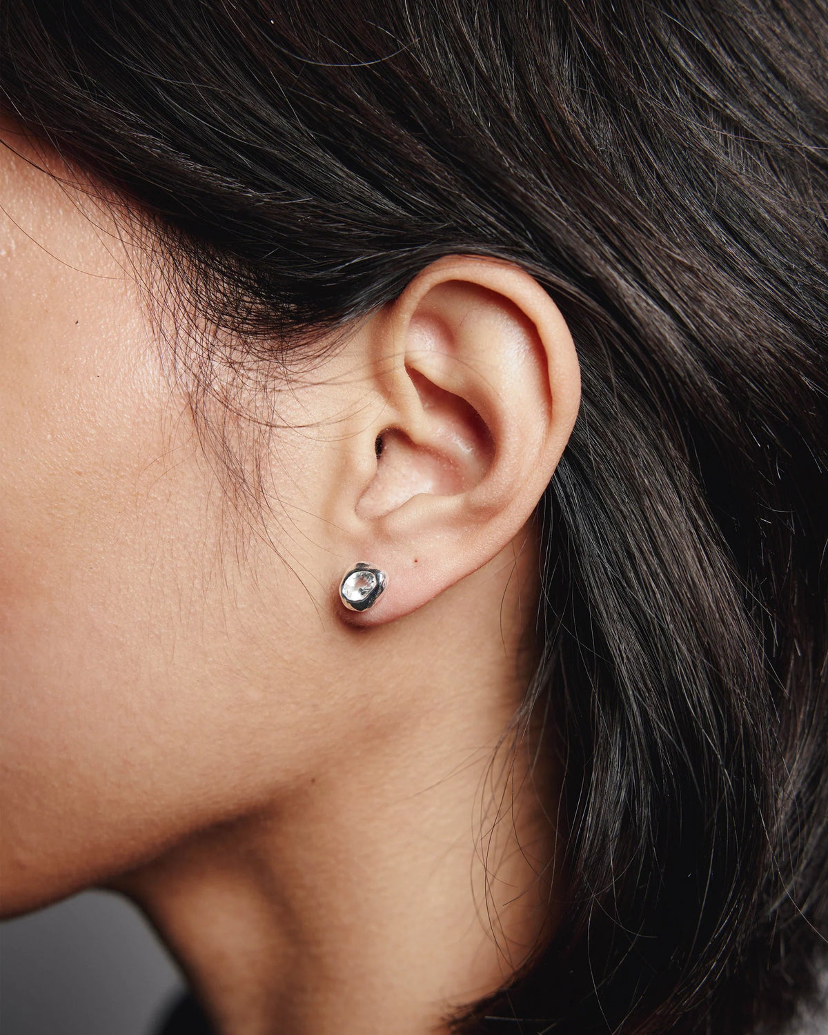 silver stud earrings with gem in the middle
