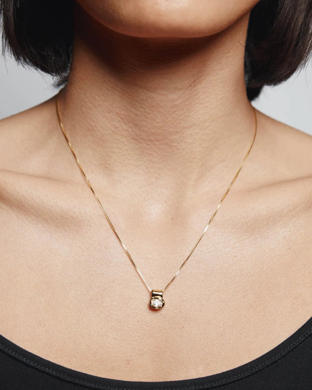 gold necklace with a stone pendant 