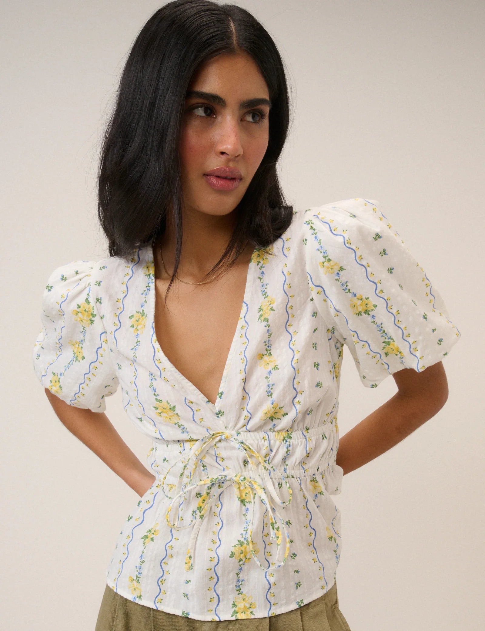 white top with a puff sleeve and yellow flowers