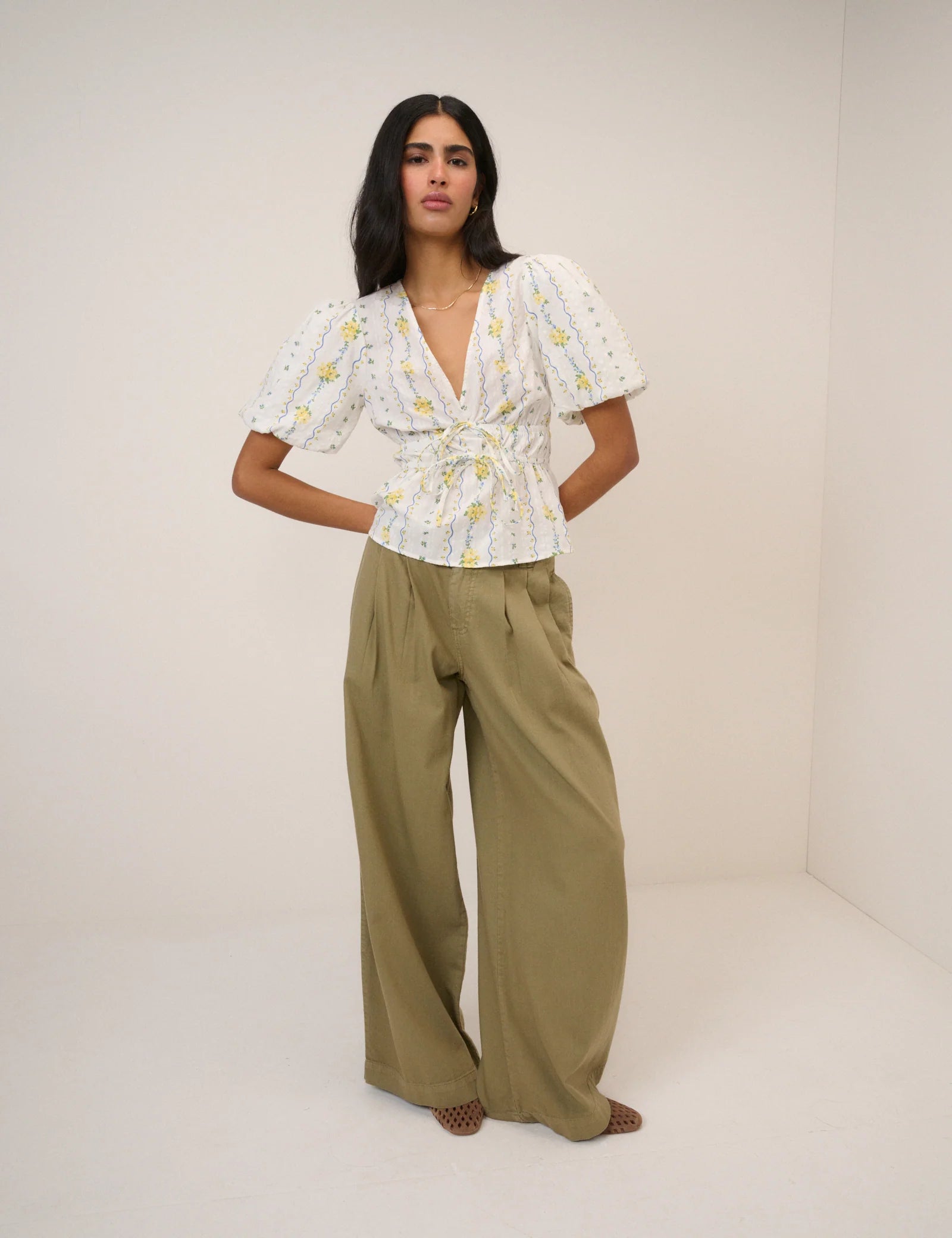 white top with a puff sleeve and yellow flowers
