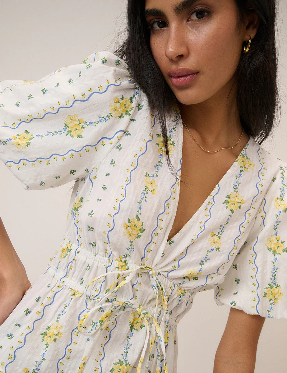 white top with a puff sleeve and yellow flowers