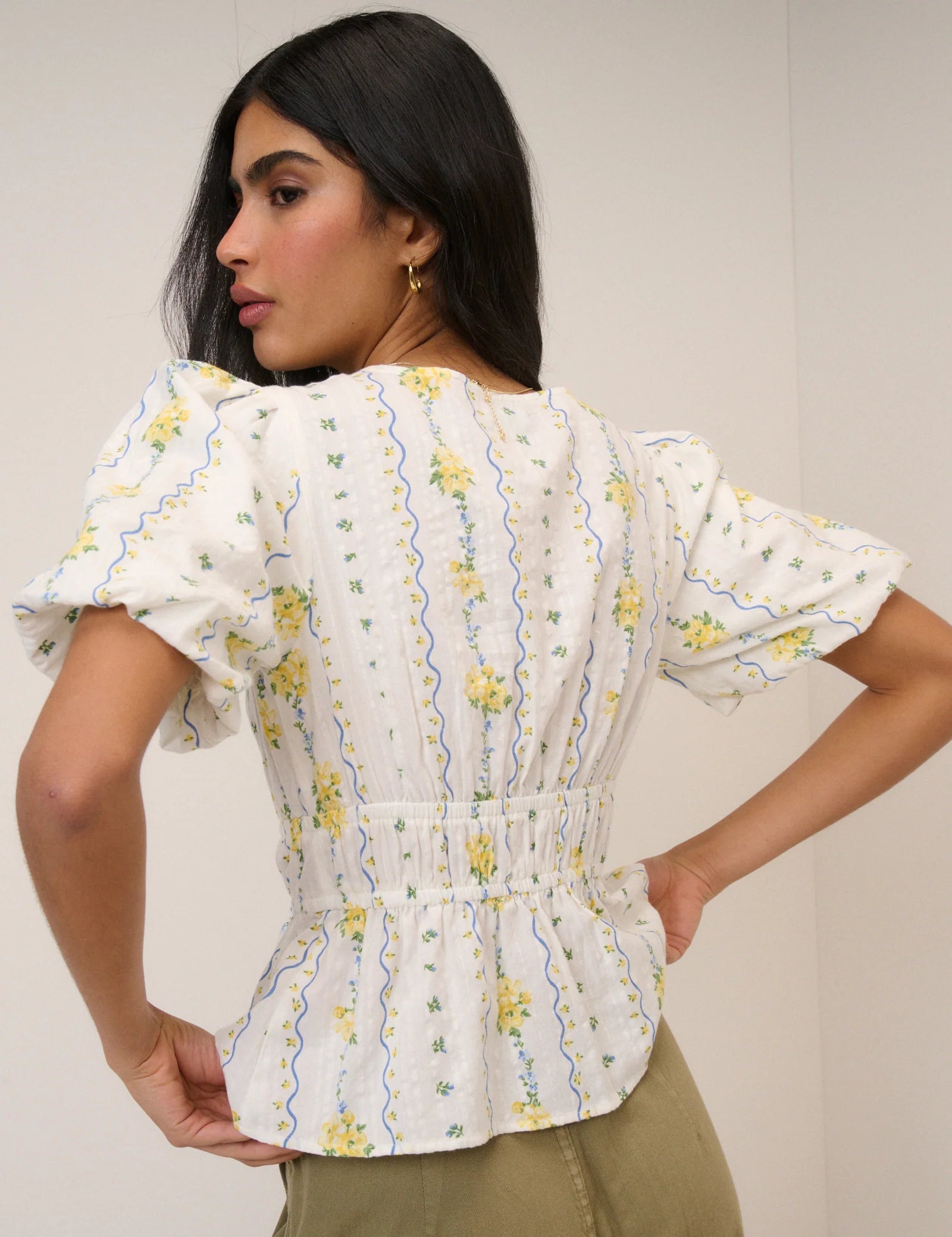 white top with a puff sleeve and yellow flowers