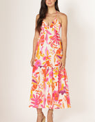 maxi dress that has a tiered bottom half and a pink and orange floral pattern