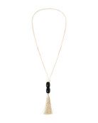 long white necklace with black beads and a tassel at the end