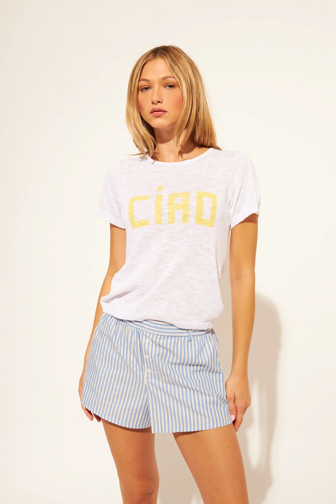 white tee with ciao written in yellow