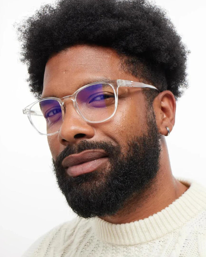 a man wears a pair of bold clear eyeglasses for blue light by Barner