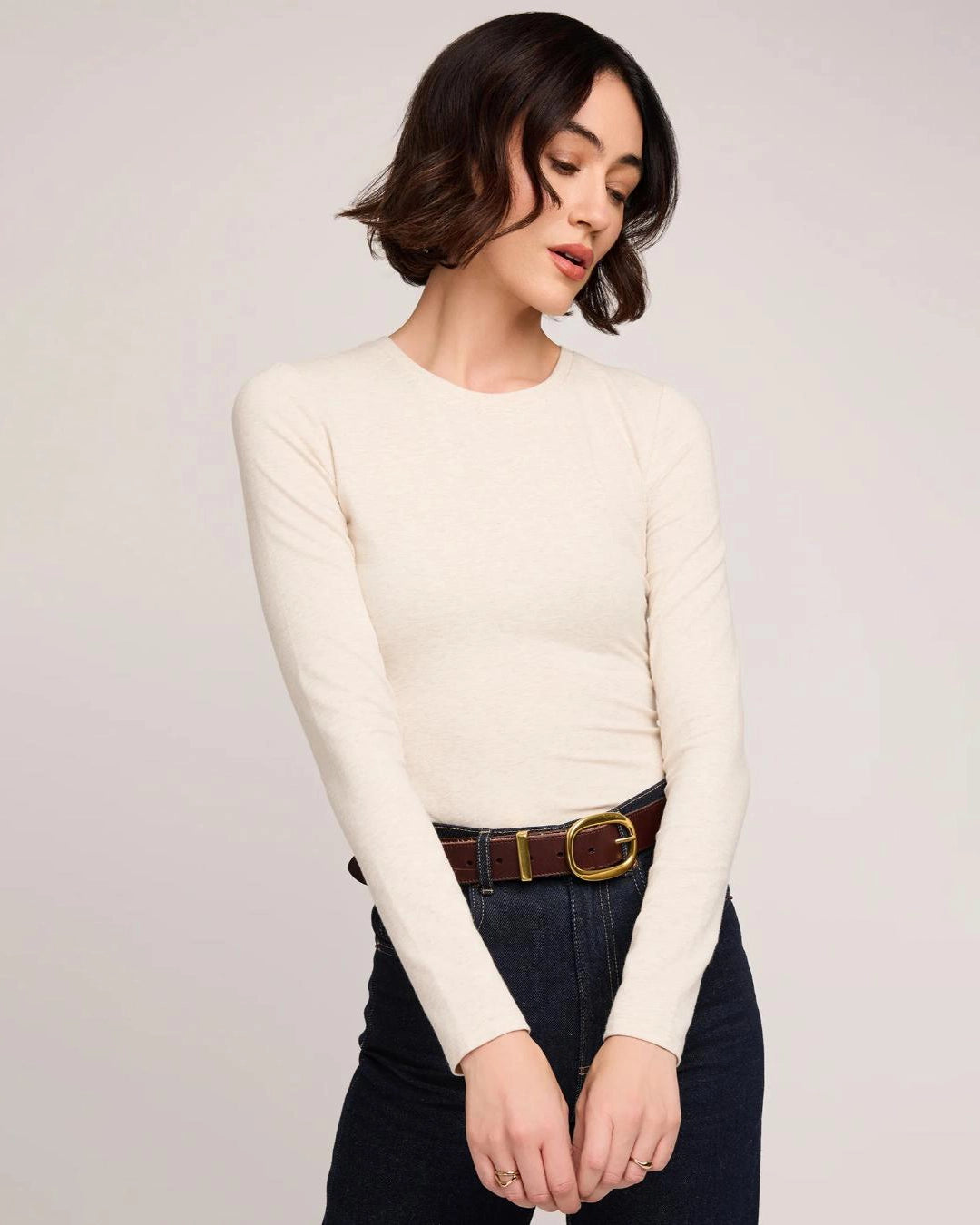 Woman wearing a cream long sleeve top