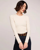 Woman wearing a cream long sleeve top